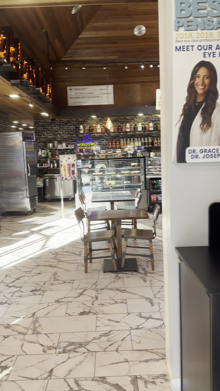 Inside My Eye Guy at Coffee Guy Underground in Pensacola — cafe seating and the optometry counter